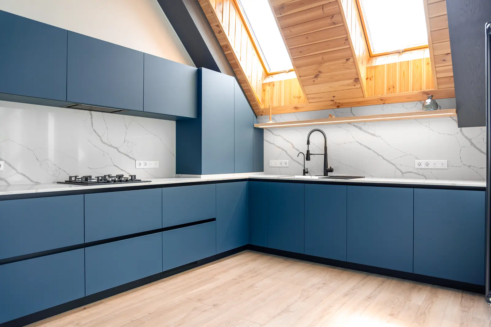 Kitchen with blue painted cabinets and white marble