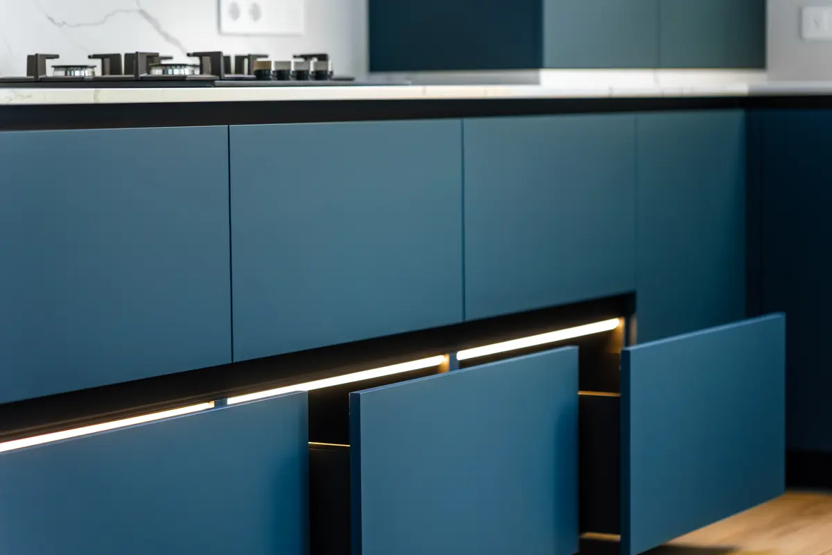 Blue painted kitchen cabinets with under cabinet lighting