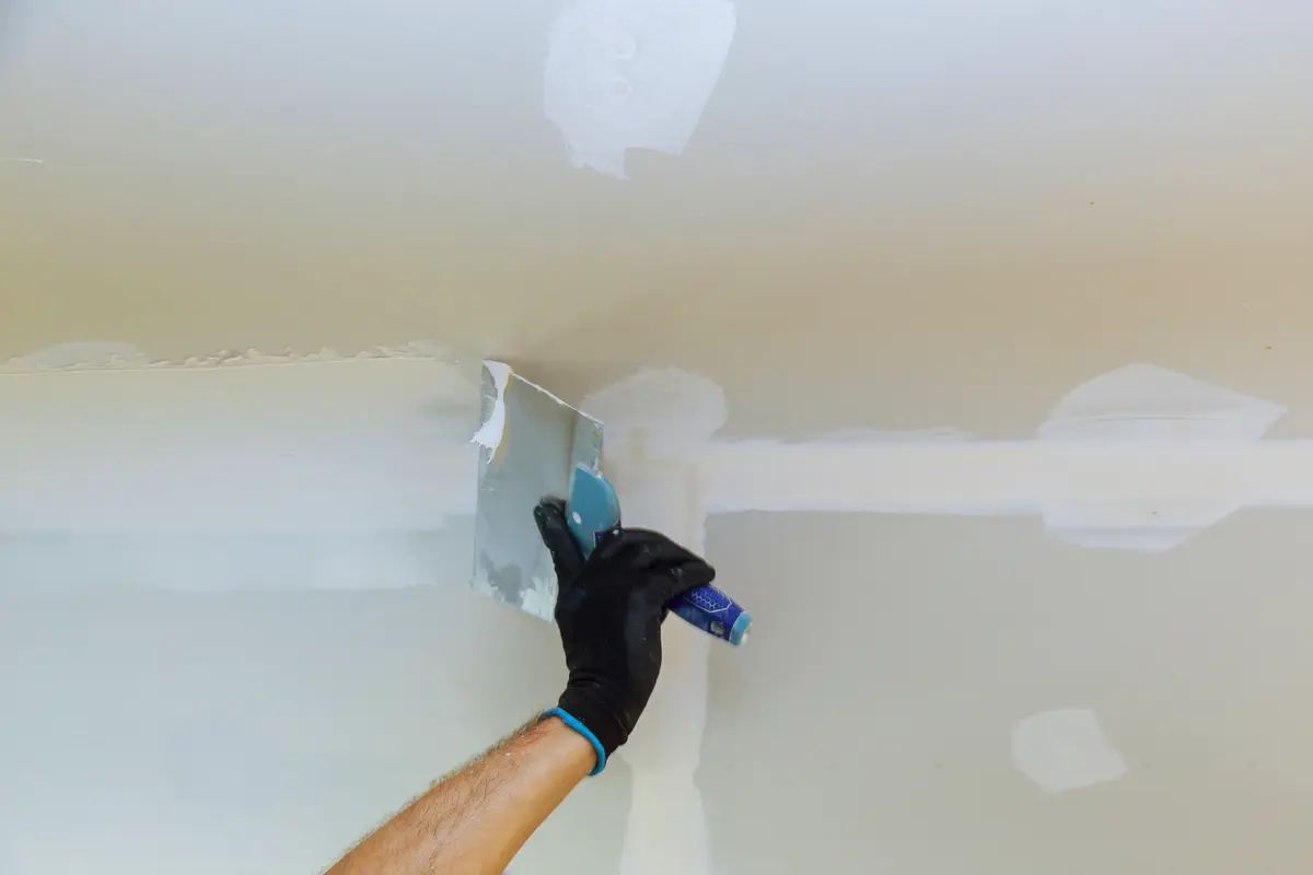 Trowel smoothing joint compound on a wall