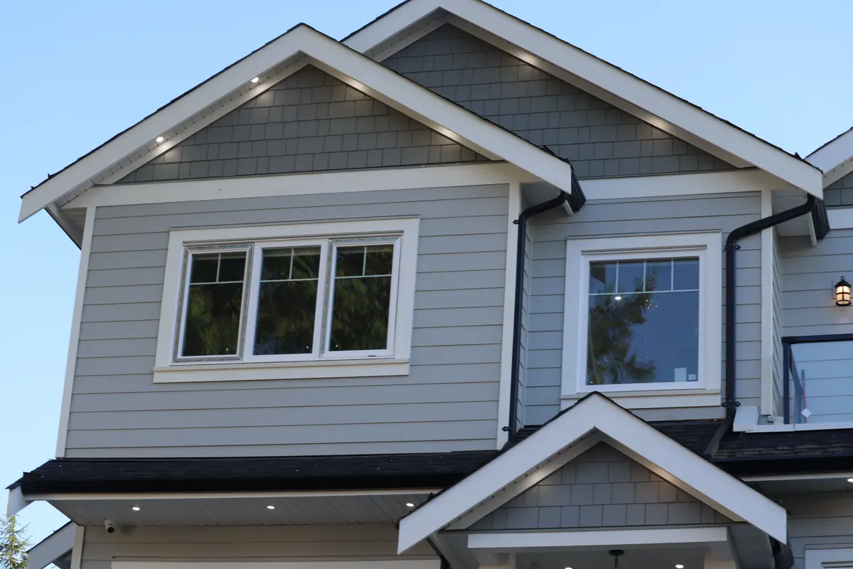 Two story home with gray siding and white trim