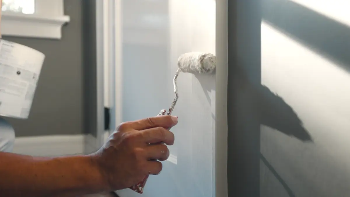 Painter rolling an interior door