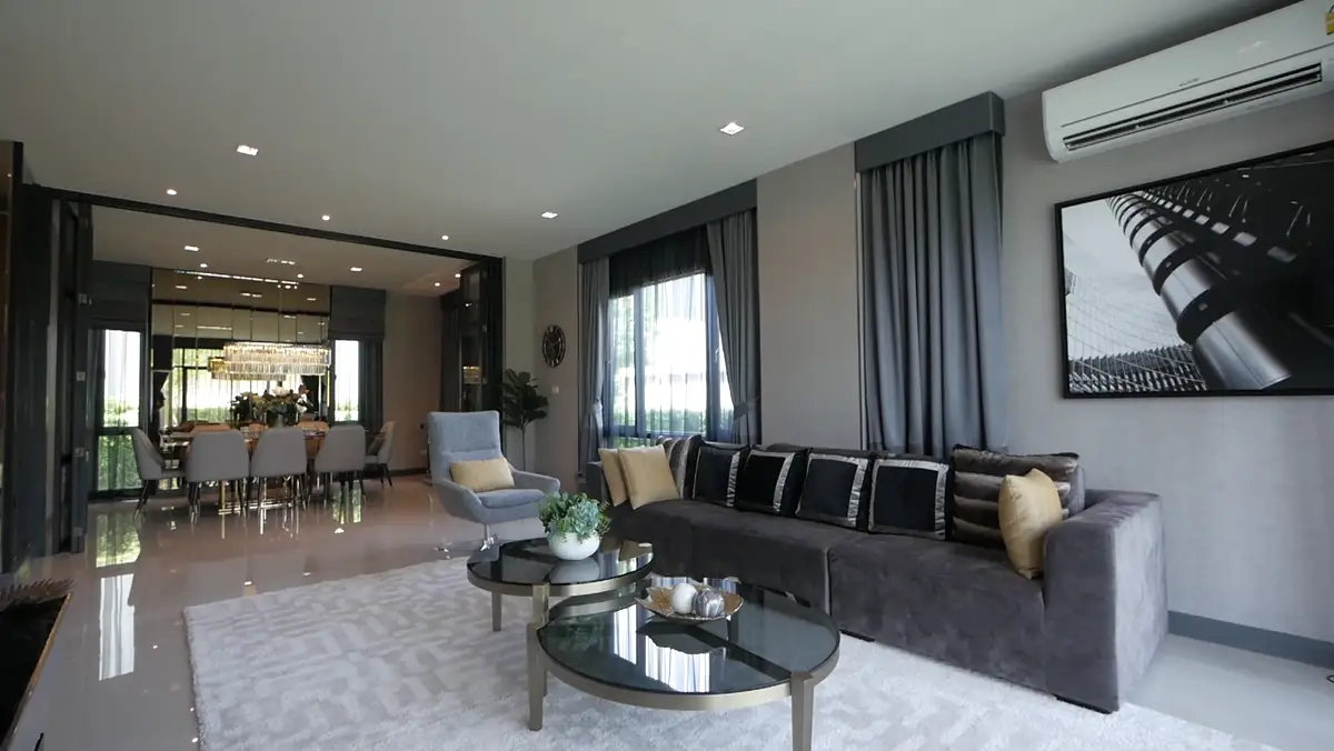 Open living and dining room with soft gray walls